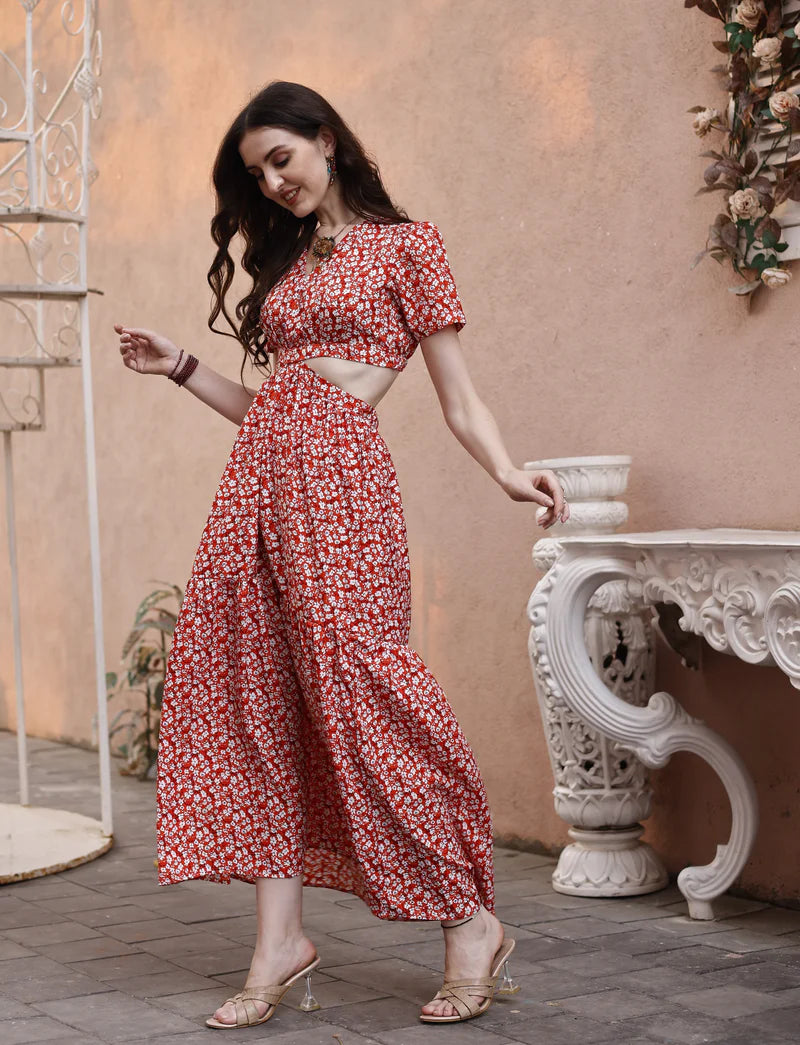 Woman wearing a red floral cutout maxi dress with puff sleeves and heeled sandals outdoors